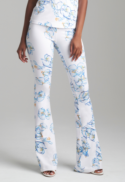 Woman wearing blue and white floral printed stretch knit pants by Ala von Auersperg for spring 2024