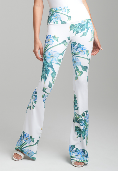 Woman wearing green mock coffee flower printed stretch knit pants by Ala von Auersperg for resort 2023