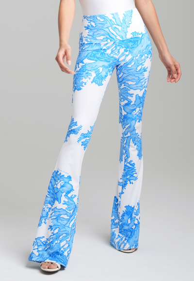 Woman wearing blue coral printed stretch knit pants by Ala von Auersperg for resort 2023