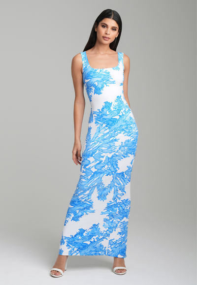 Woman wearing blue coral printed long square neck stretch knit dress by Ala von Auersperg for resort 2023