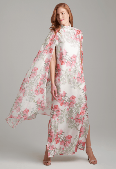 Woman wearing flower printed long turtleneck silk dress with silk attached cape by Ala von Auersperg for spring summer 2022