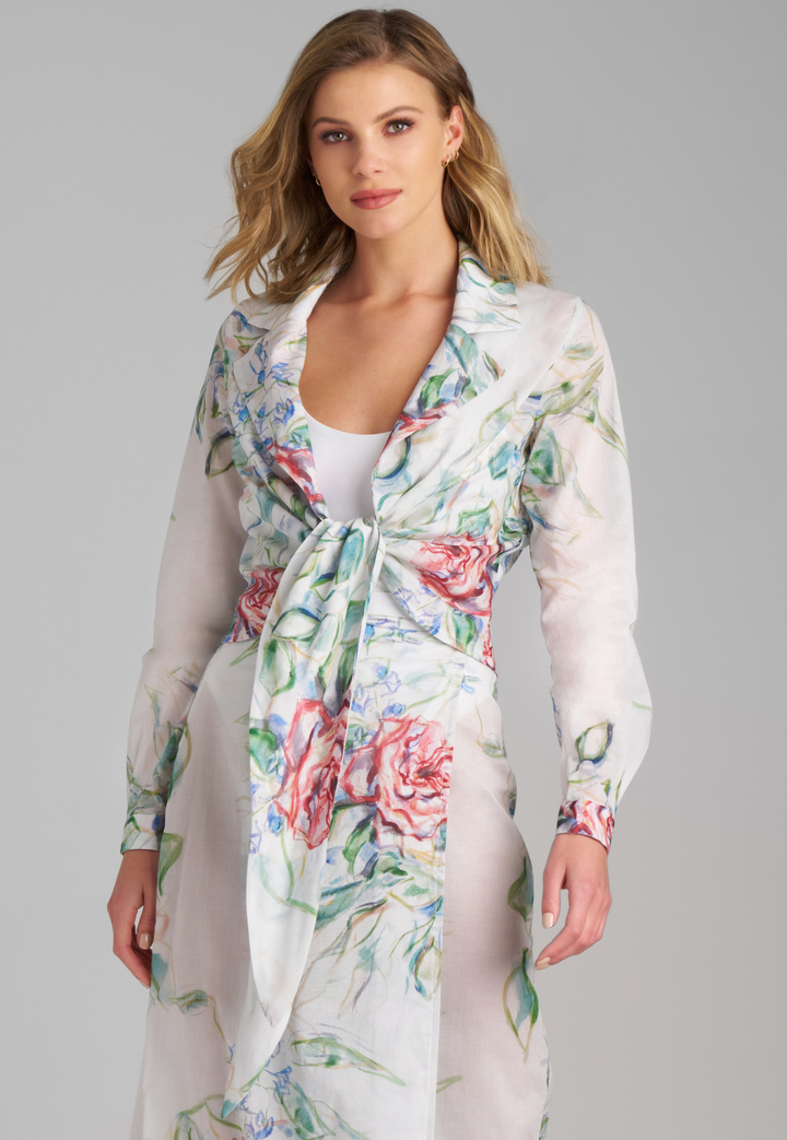 Woman wearing rose printed cotton wrap top with wrap cotton skirt by Ala von Auersperg for summer 2023