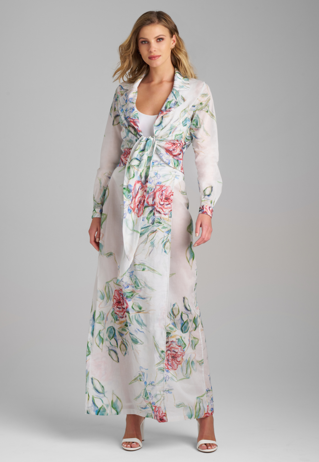 Woman wearing rose printed cotton wrap top with wrap cotton skirt by Ala von Auersperg for summer 2023