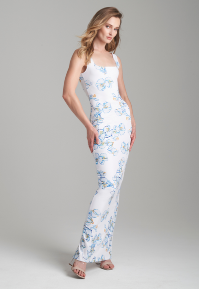 Woman wearing long stretch knit blue and white floral printed dress by Ala von Auersperg for spring 2024