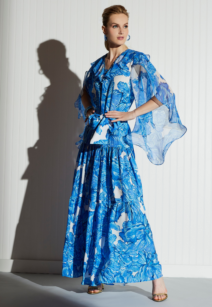 Woman wearing silk floral printed formal dress in a blue floral by designer Ala von Auersperg for women's luxury clothing