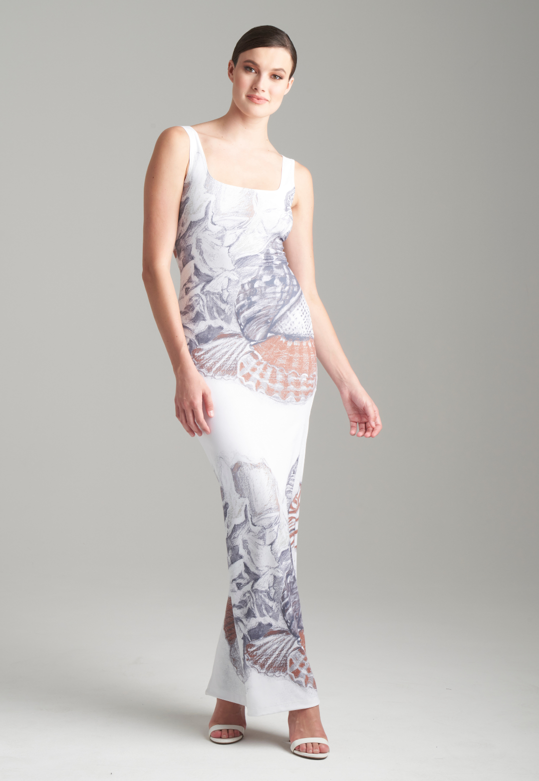 Woman wearing shell printed white long stretch knit dress by Ala von Auersperg for resort 2024
