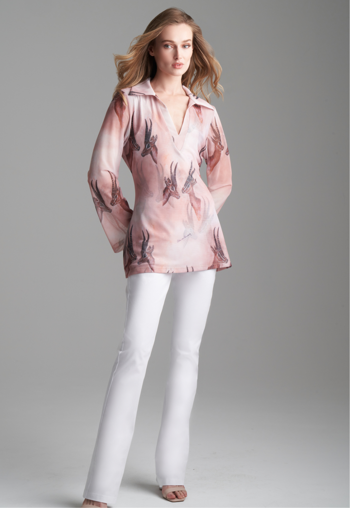 Woman wearing mesh v-neck sweater with organza collar in brown deer print paired with white stretch knit pants by Ala von Auersperg for fall 2023