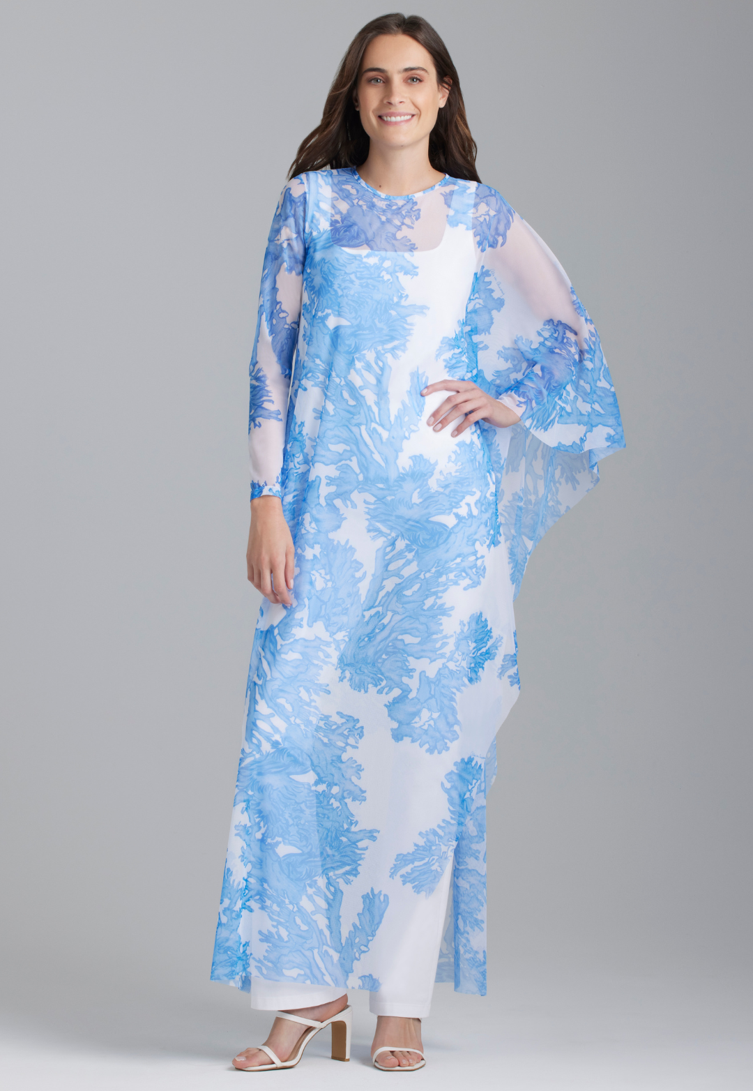 Woman wearing blue silk yucca printed long kaftan with v neck by Ala von Auersperg for spring 2023