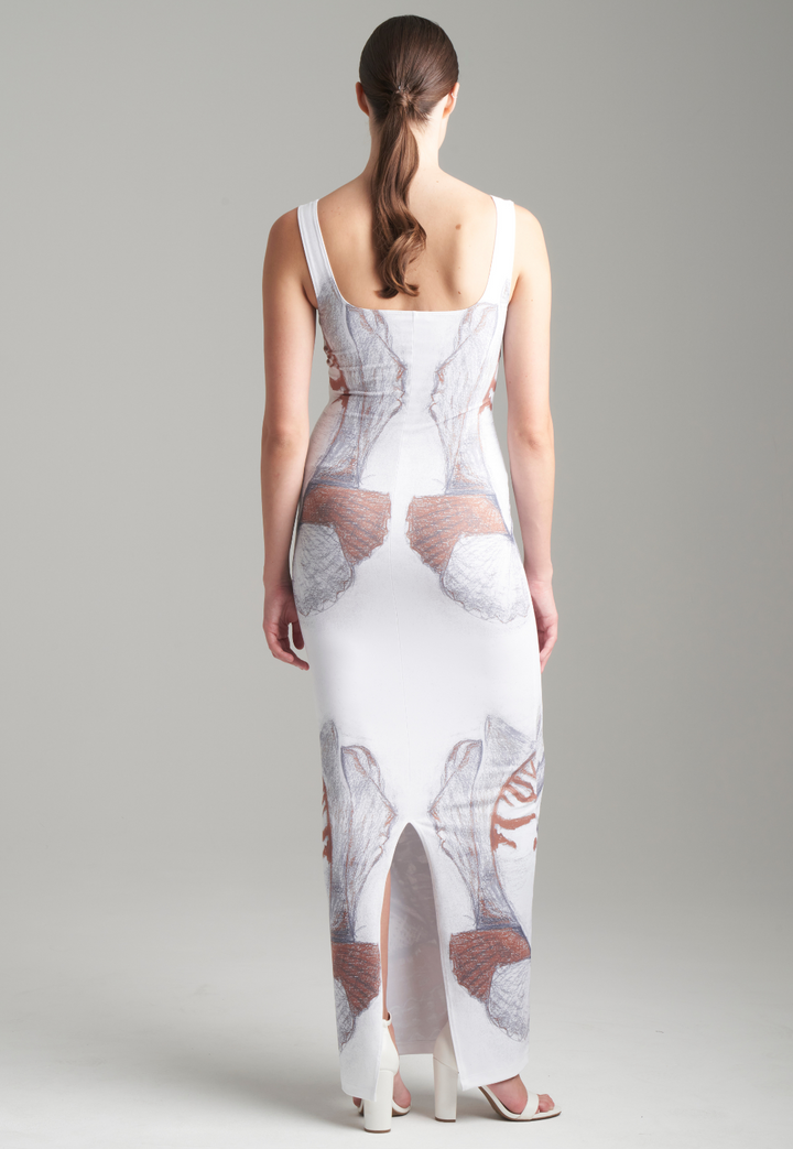 Woman wearing shell printed white long stretch knit dress by Ala von Auersperg for resort 2024