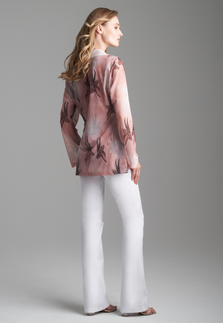 Woman wearing mesh v-neck sweater with organza collar in brown deer print paired with white stretch knit pants by Ala von Auersperg for fall 2023