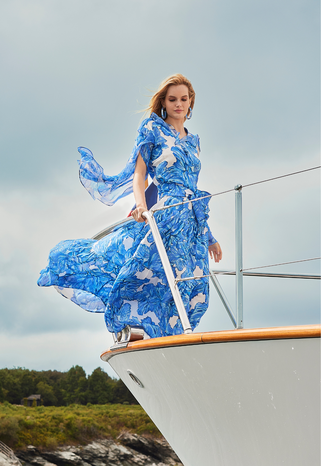 Woman wearing silk formal blue floral printed dress by Ala von Auersperg for women's luxury fashion 