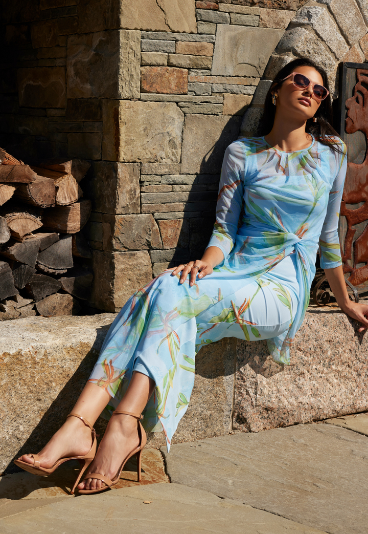 Woman wearing mesh topper n green blue bamboo mesh over a long stretch knit green blue bamboo printed dress by Ala von Auersperg for resort 2024