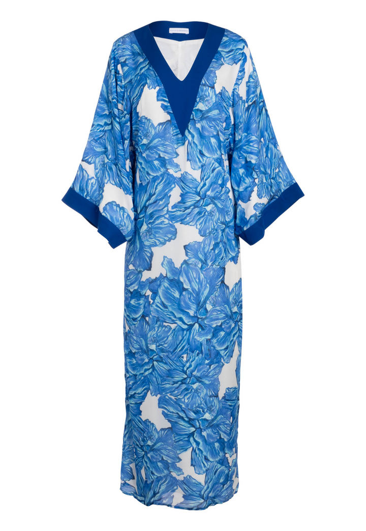 Flat image of a silk blue floral kaftan with silk blue trim by designer Ala von Auersperg for luxury resort clothing