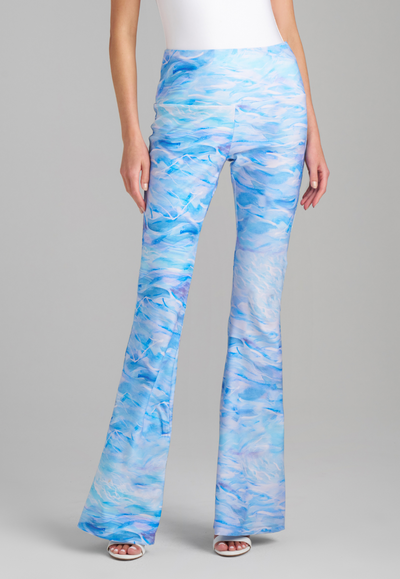 Woman wearing blue wave printed stretch knit pant by Ala von Auersperg for summer 2023