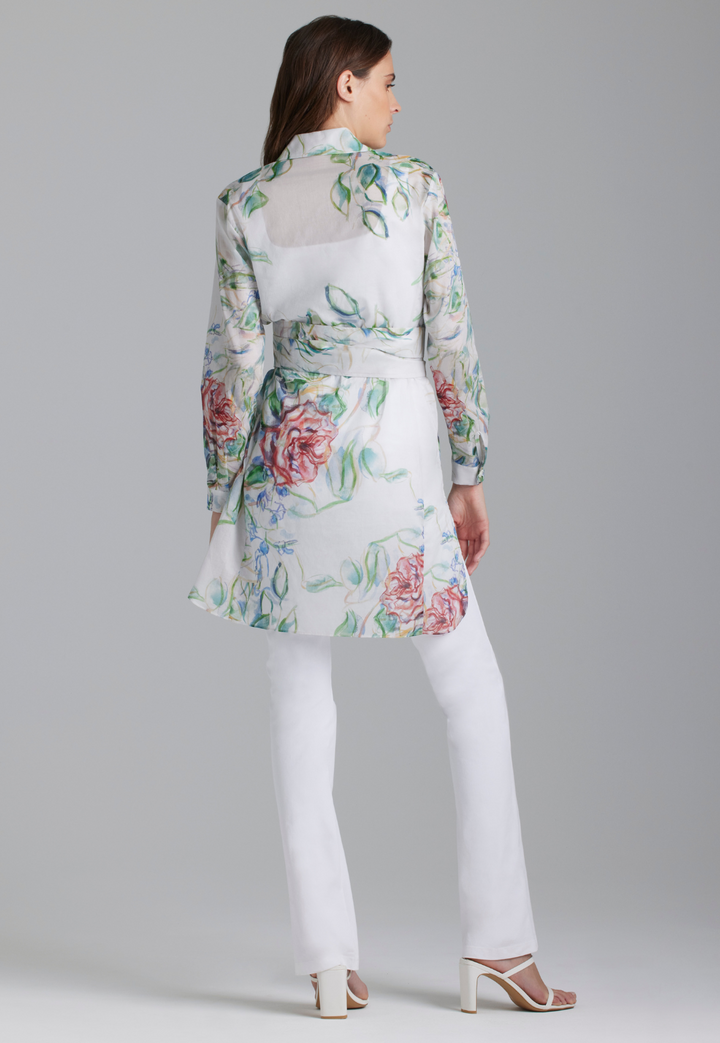Woman wearing rose printed cotton tunic with belt and italian stretch cotton white pants by Ala von Auersperg