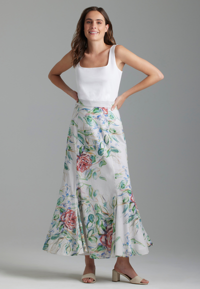 Woman wearing rose printed cotton skirt and white italian stretch cotton tank top by Ala von Auersperg for summer 2023