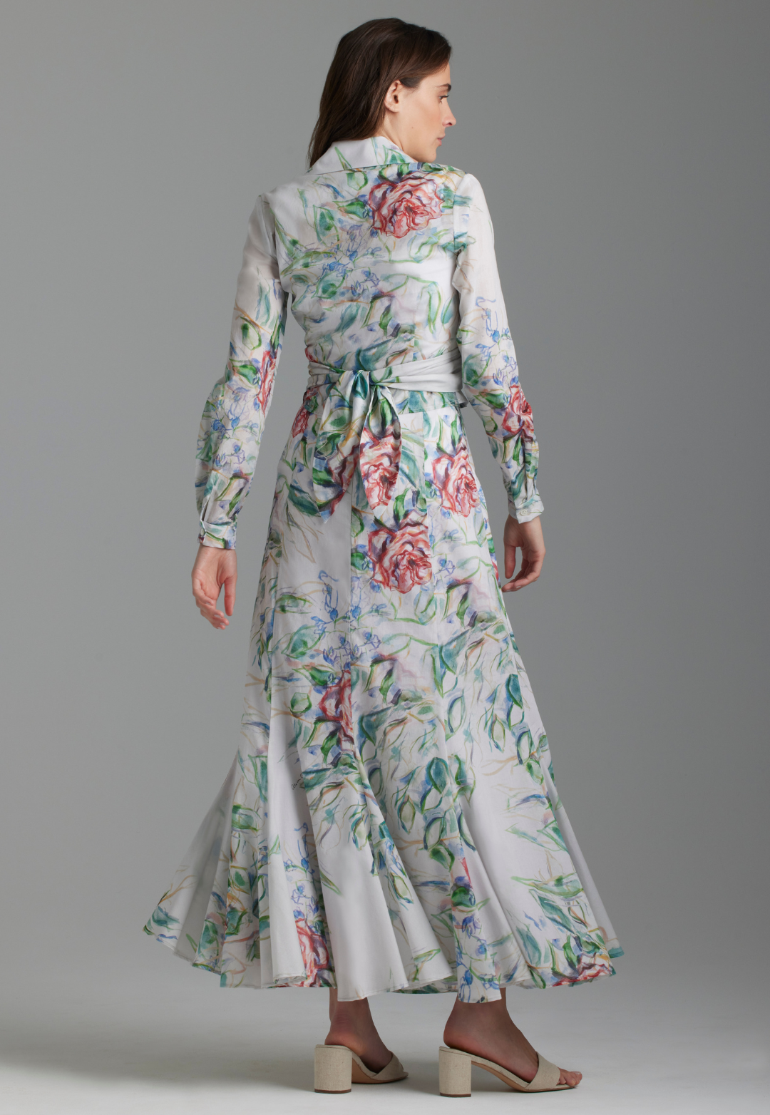 Woman wearing cotton wrap top and skirt in rose print by Ala von Auersperg for summer 2023