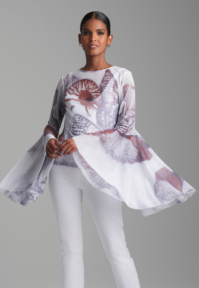 Woman wearing mesh white shell printed shirt with bell flounce sleeves over white italian stretch cotton tank top and pants by Ala von Auersperg for resort 2024