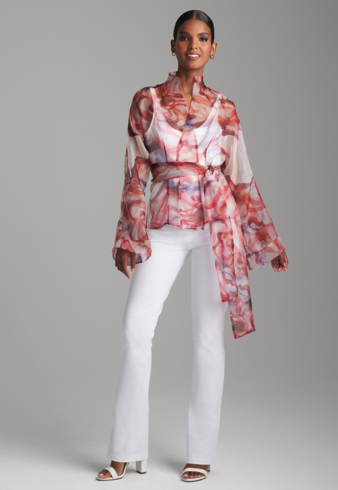 Woman wearing red rose printed silk organza kimono blouse with high neckline and belt over italian stretch cotton white tank top and pants by Ala von Auersperg