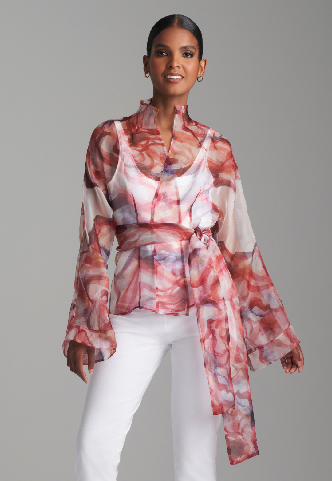 Woman wearing red rose printed silk organza kimono blouse with high neckline and belt over italian stretch cotton white tank top and pants by Ala von Auersperg