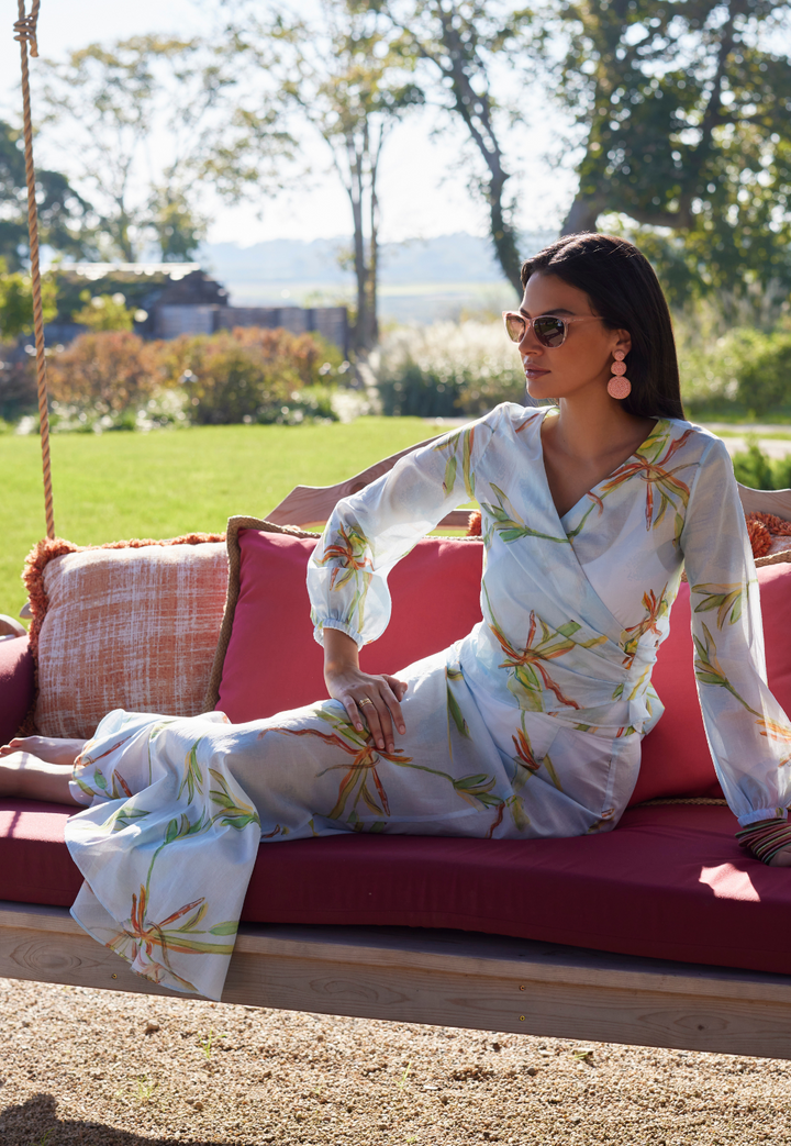 Woman wearing cotton bamboo printed wrap top with long flounce skirt by Ala von Auersperg for resort 2024