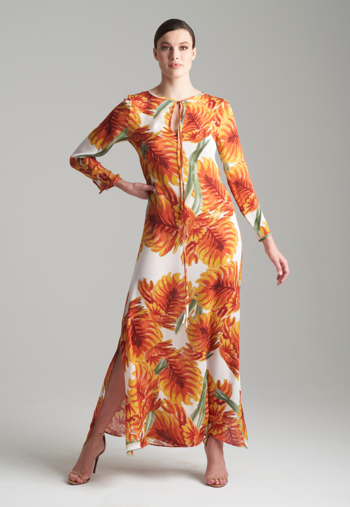 Woman wearing orange and white leaf printed long silk dress kaftan  with keyhole detail and side slit