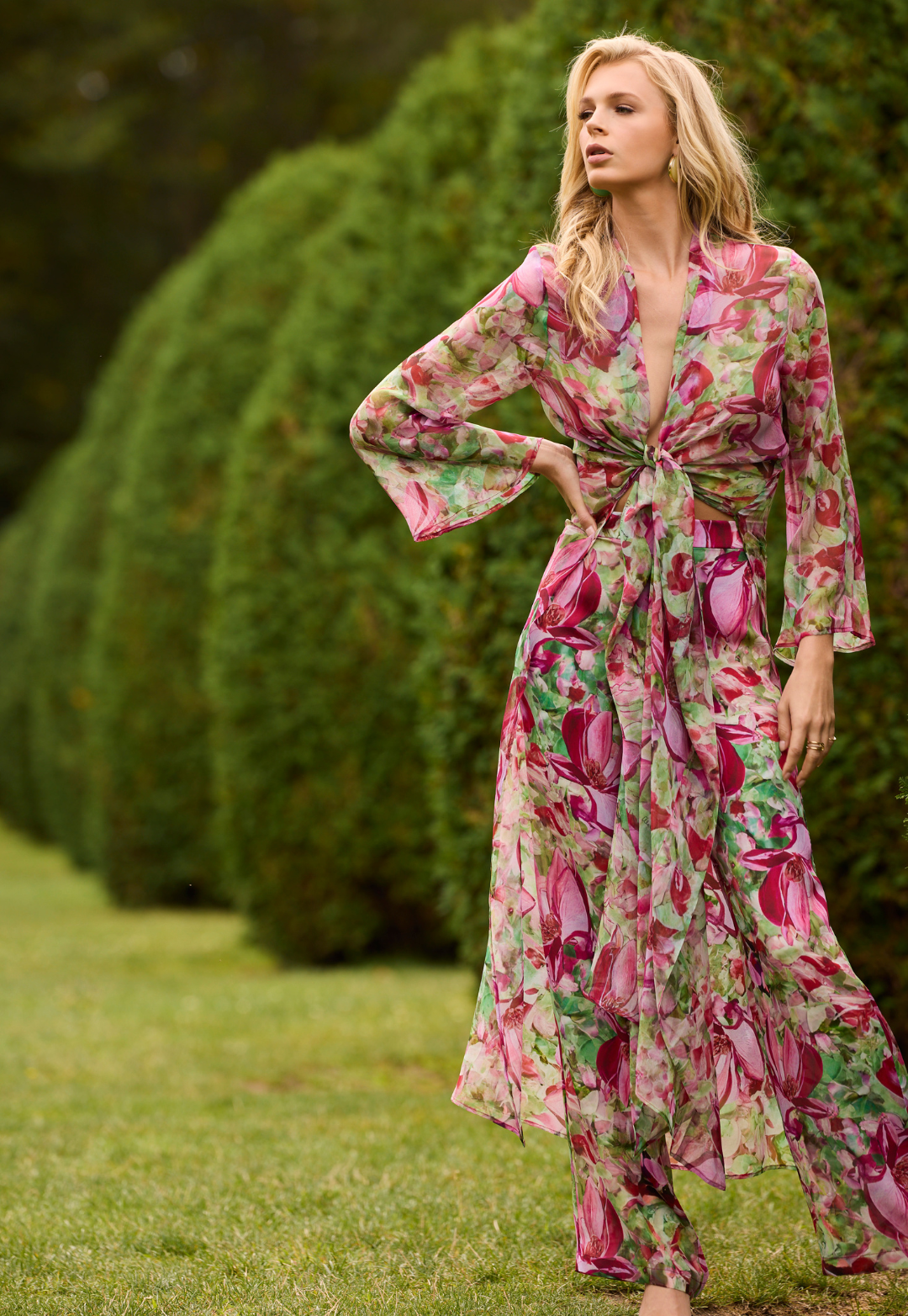 Woman wearing a silk floral printed duster with matching silk pants