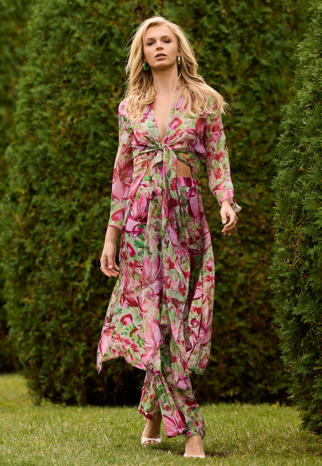 Woman wearing silk duster and silk pants in a matching floral print