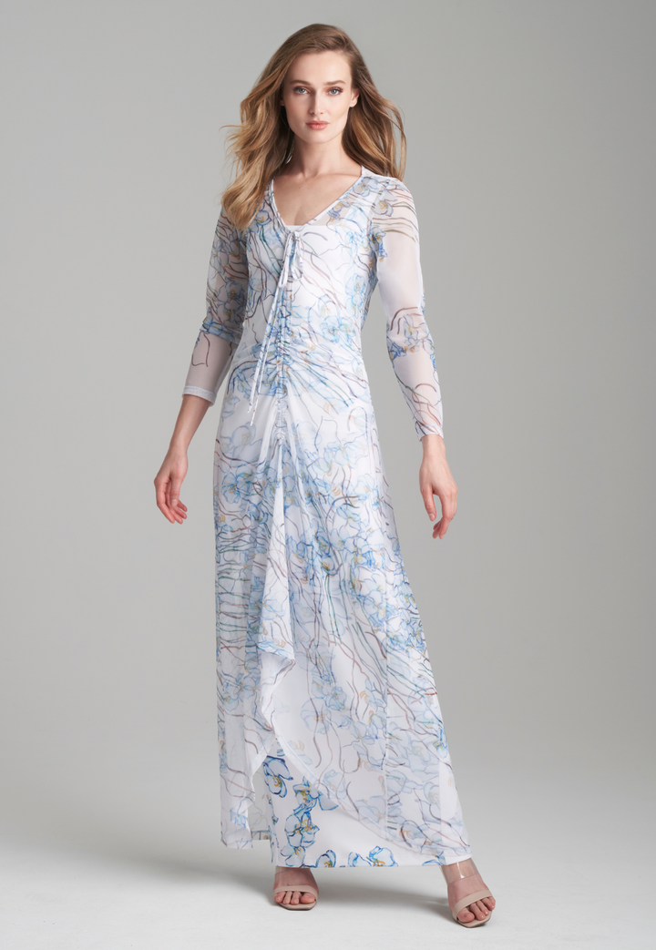 Woman wearing mesh drawstring sheer dress over long stretch knit white dress with blue orchids by Ala von Auersperg for spring 2024