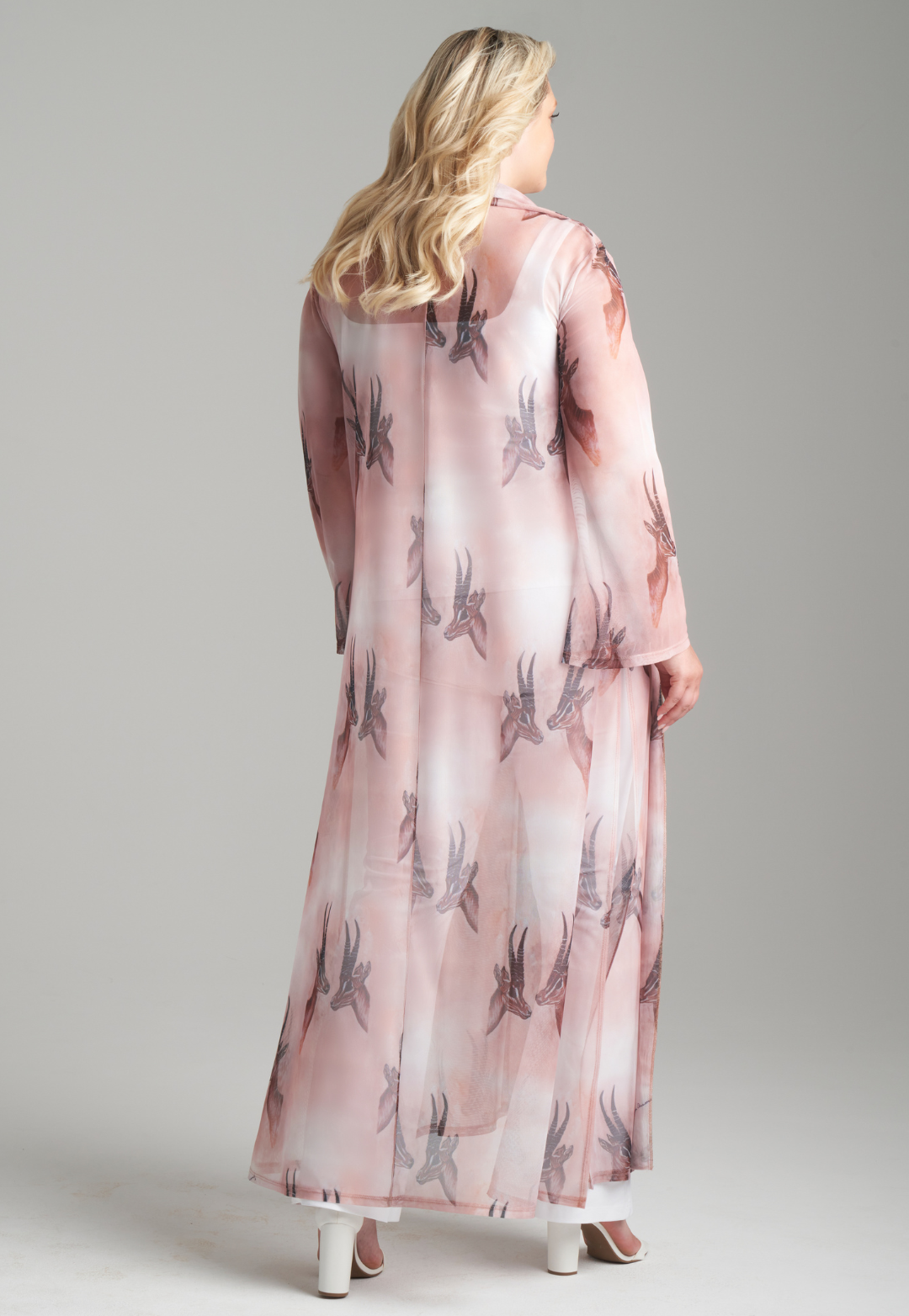 Woman wearing long mesh duster robe in brown deer print over white stretch knit tank top and pants by Ala von Auersperg for fall 2023