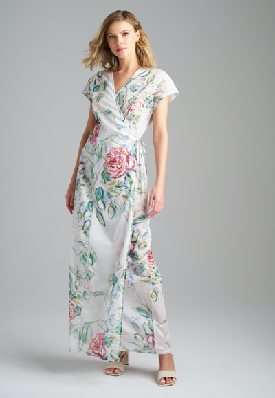Woman wearing rose printed cotton wrap dress with v neck, side tie, and short sleeves by Ala von Auersperg for summer 2023