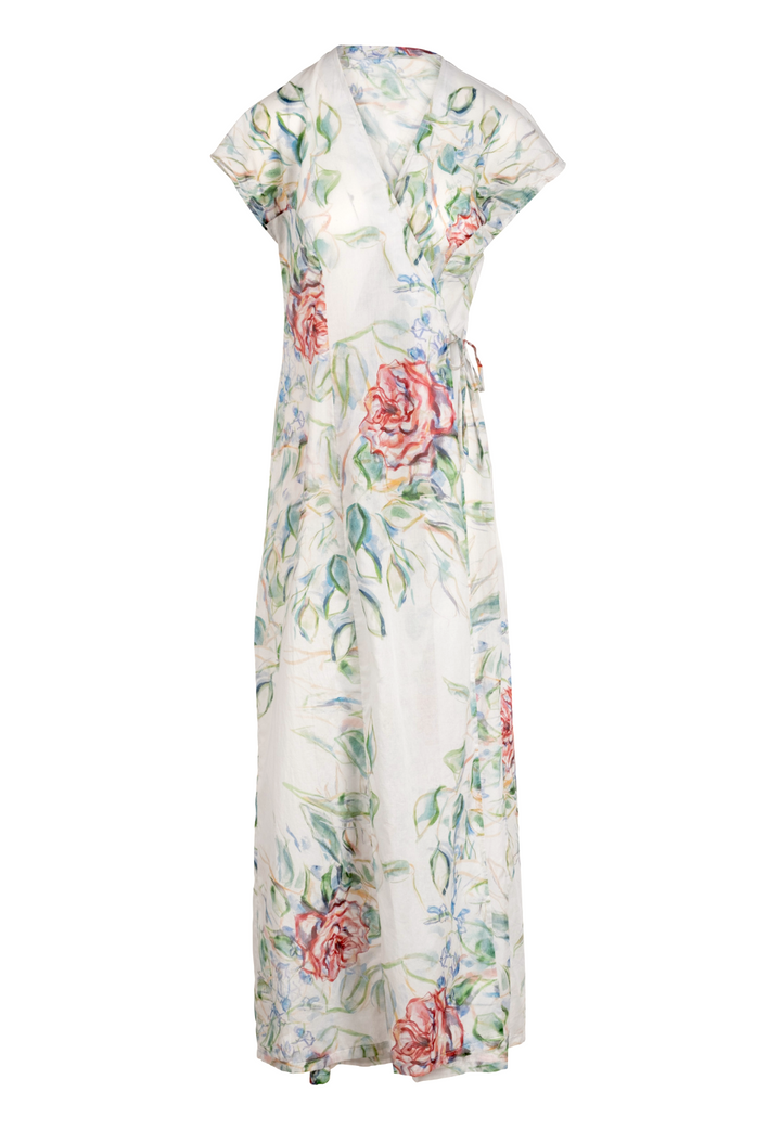 Woman wearing rose printed cotton wrap dress with v neck, side tie, and short sleeves by Ala von Auersperg for summer 2023