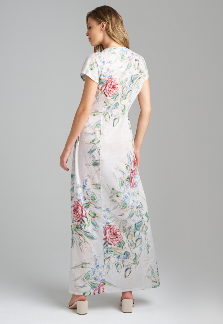 Woman wearing rose printed cotton wrap dress with v neck, side tie, and short sleeves by Ala von Auersperg for summer 2023