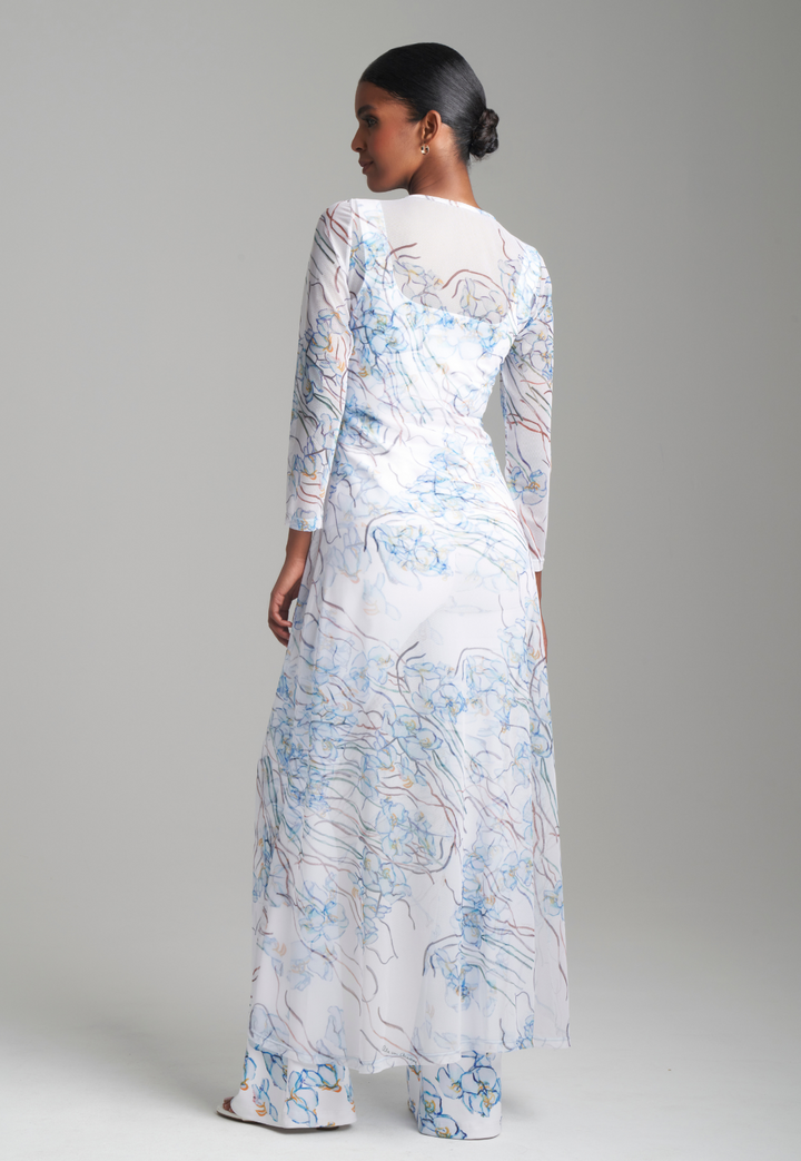 Woman wearing mesh drawstring orchid printed outfit topper over matching stretch knit tank top and pants by Ala von Auersperg for spring 2024