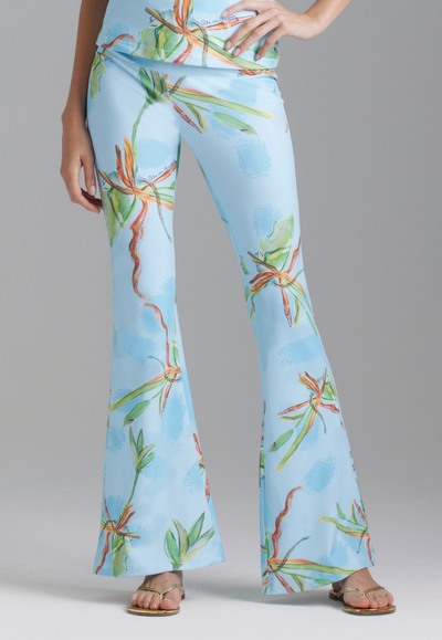 Woman wearing blue green bamboo printed stretch knit pants with matching printed tank top by Ala von Auerperg for resort 2024