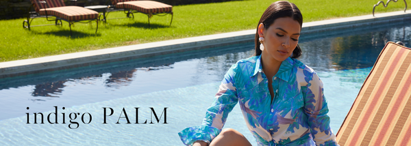 Indigo Palm | Woman wearing blue palm leaf printed blouse by the pool by Ala von Auersperg for women's warm weather clothing