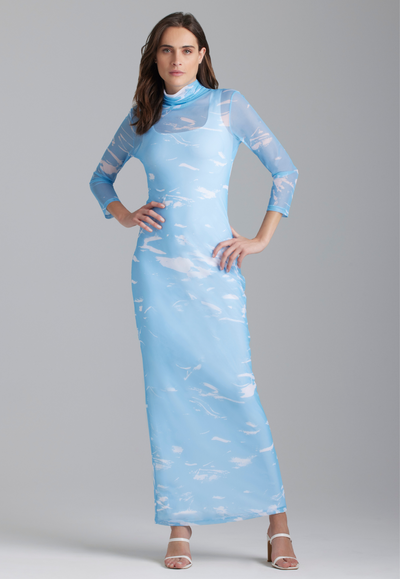 Woman wearing wave printed mesh turtlneck dress over white long stretch knit dress by Ala von Auersperg for summer 2023