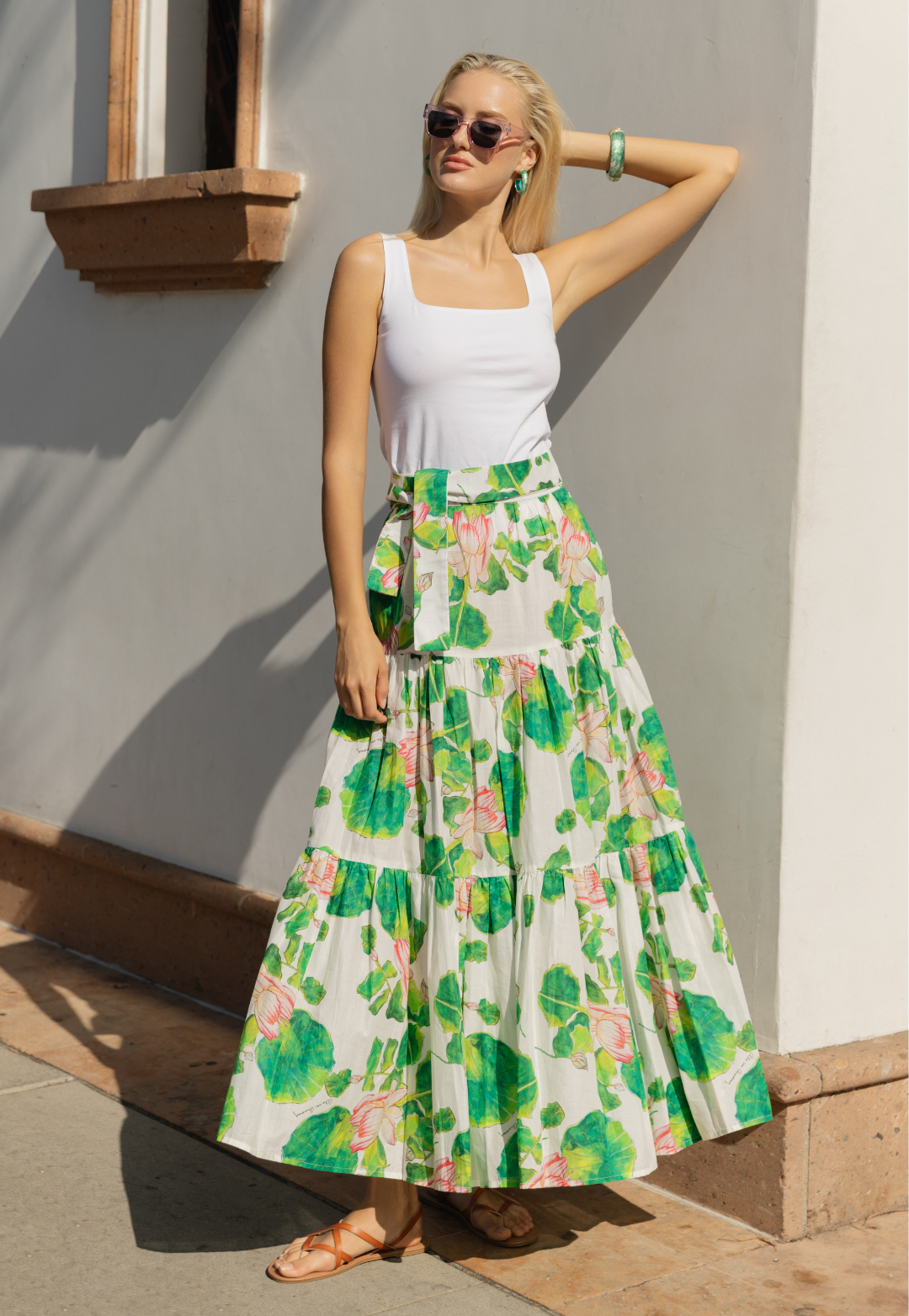 Woman wearing white tank top with floral peasant skirt