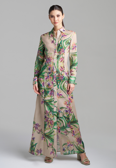 Woman wearing khaki colored cotton shirt dress with purple orchids by Ala von Auersperg for fall 2023