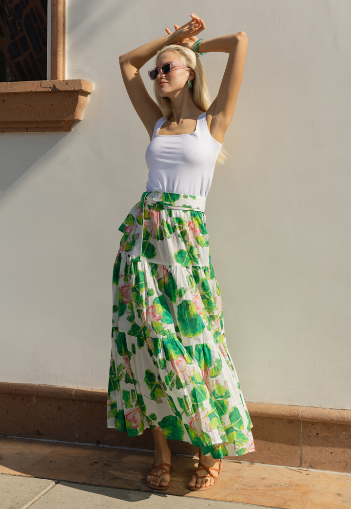 Woman wearing a white tank top with a cotton floral peasant skirt