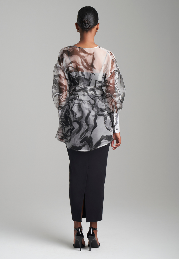 Woman wearing black rose printed silk organza balloon blouse with belt over black italian stretch cotton tank top and pencil skirt by Ala von Auersperg