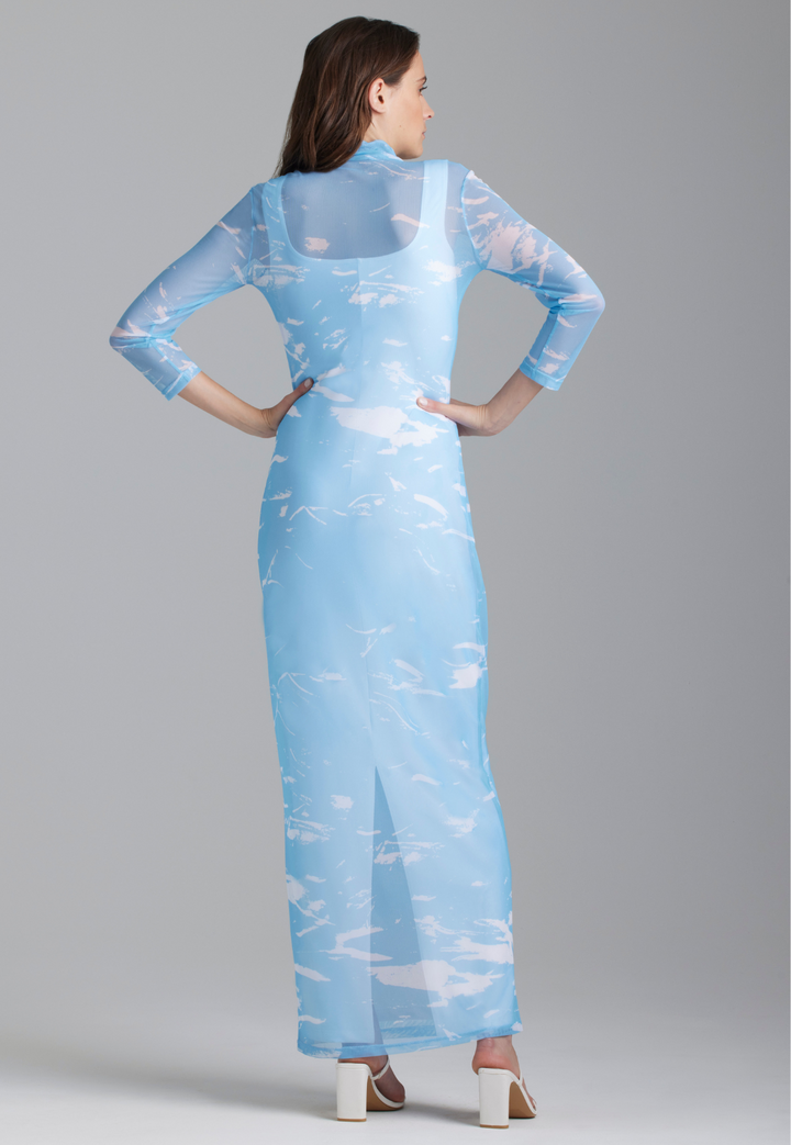 Woman wearing wave printed mesh turtlneck dress over white long stretch knit dress by Ala von Auersperg for summer 2023