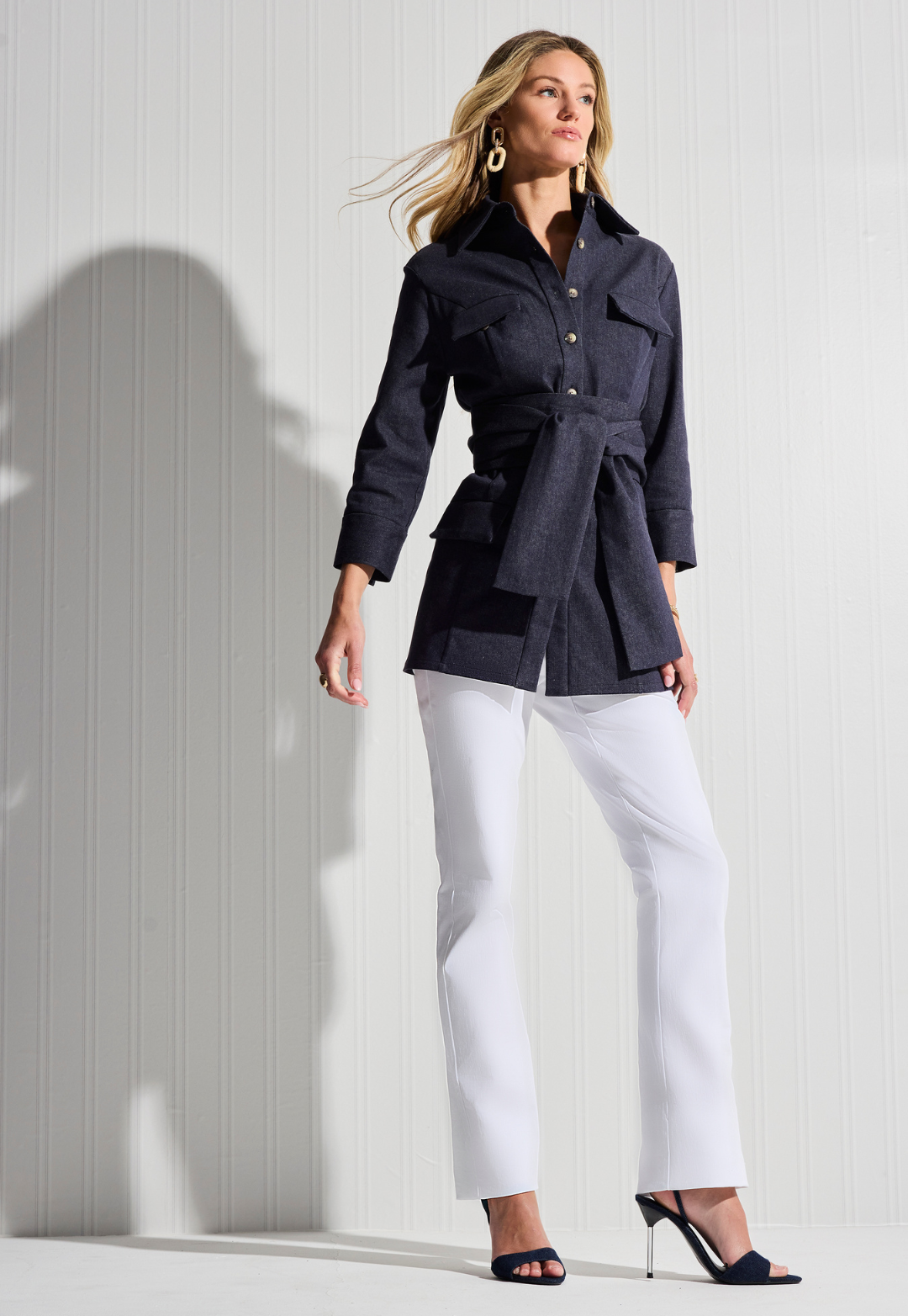 Woman wearing denim jacket with white cotton pants by designer Ala von Auersperg for womens luxury travel clothing
