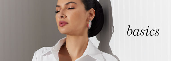 Basics | Woman wearing white dress shirt with floral earrings by designer Ala von Auersperg for women's luxury travel clothing