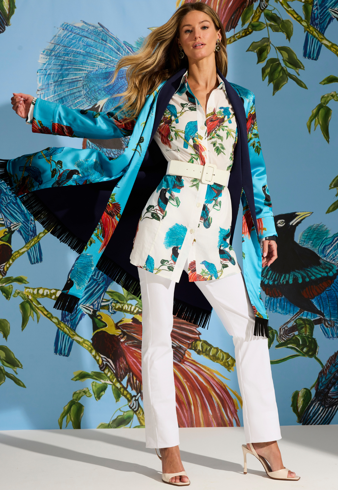 Woman wearing cotton white bird printed shirt under a silk reversible jacket with white cotton pants by designer Ala von Auersperg for womens luxury travel clothing