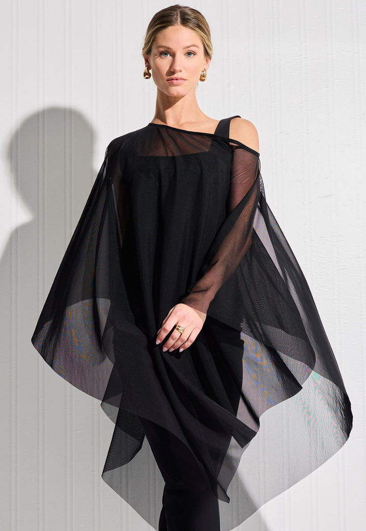 Woman wearing sheer mesh black poncho over black cotton tank top and pants by designer Ala von Auersperg for womens luxury travel clothing
