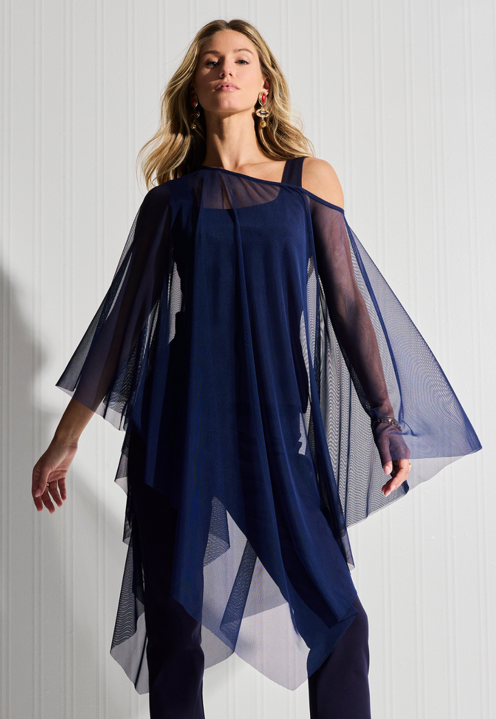 Woman wearing sheer navy poncho over cotton navy tank top and pants by designer Ala von Auersperg for womens luxury travel clothing