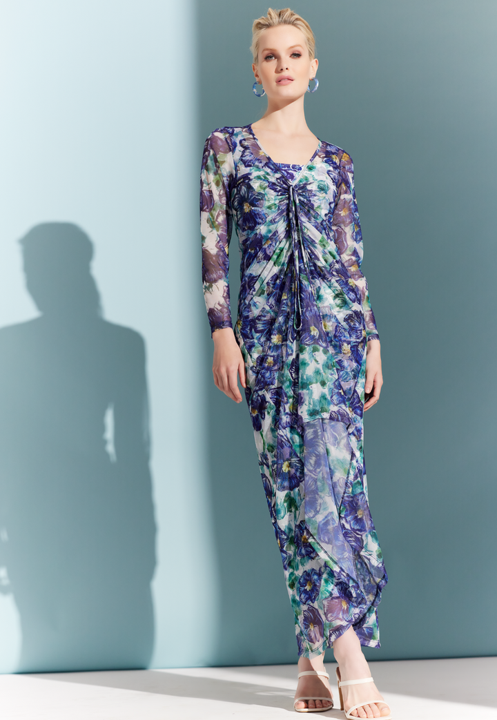 Woman wearing sheer mesh dress topper over a matching long stretch knit dress in a blue floral print by designer Ala von Auersperg for womens luxury travel clothing