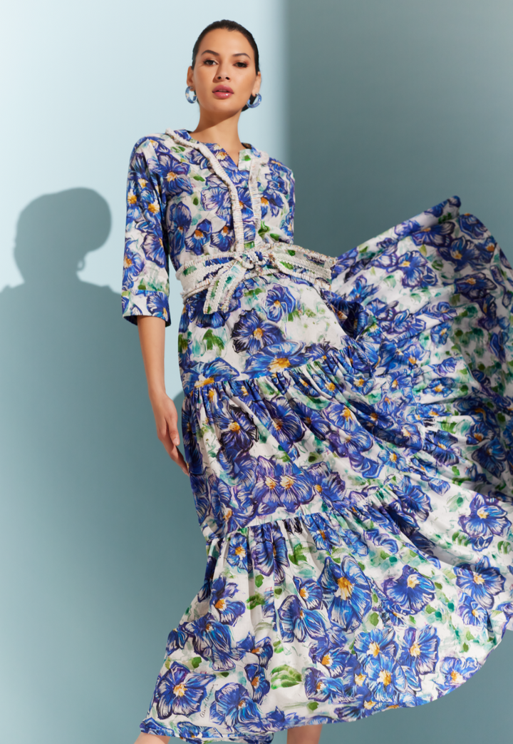 Woman wearing cotton blue floral printed maxi skirt with a matching tunic and belt by designer Ala von Auersperg for womens luxury travel clothing