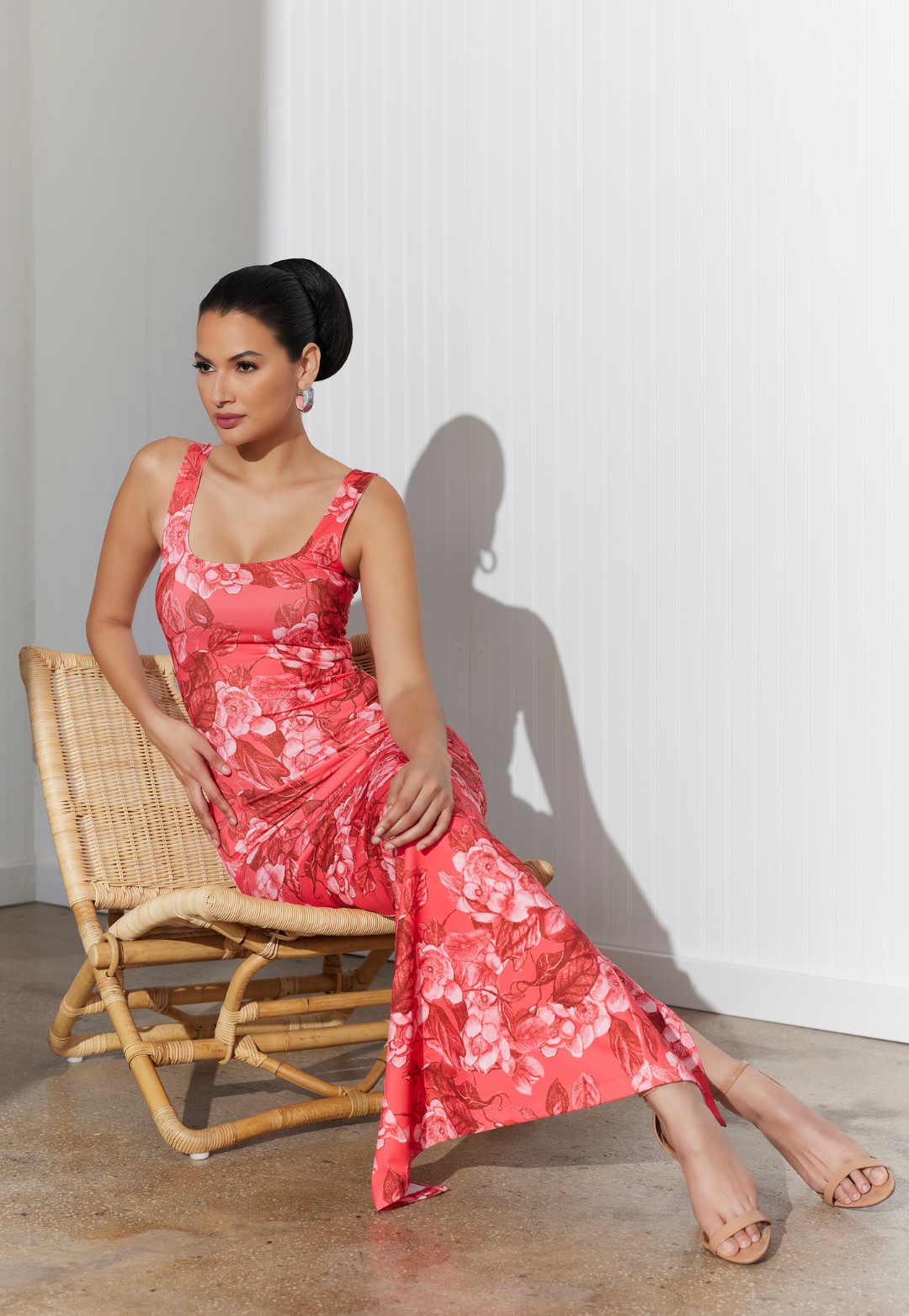 Woman wearing long red floral stretch dress by designer Ala von Auersperg for women's luxury travel clothing